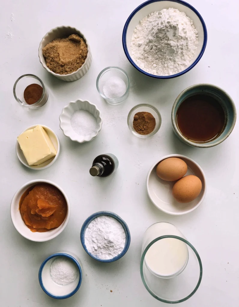 Ingredients for homemade pumpkin coffee cake arranged on a white table